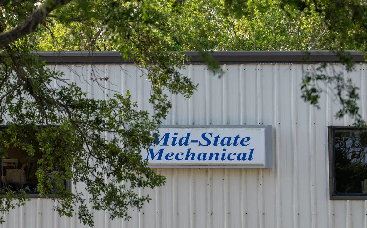 Mid-State Mechanical service team working on HVAC equipment