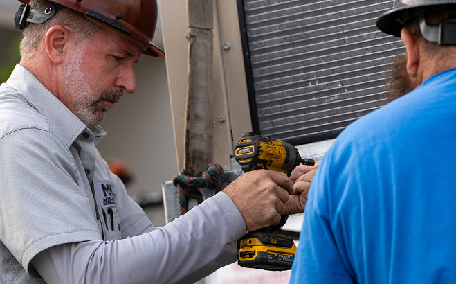 Technicians working on HVAC equipment