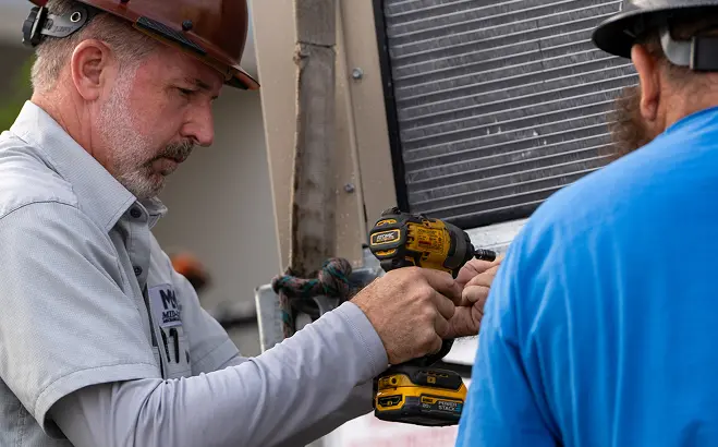 Technicians working on HVAC equipment